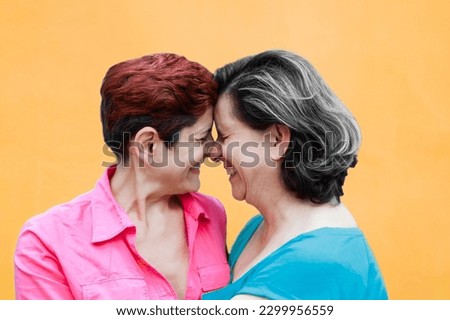 Senior gay lesbian couple enjoy tender moment outside - LGBTQ mature female lovers smiling outdoor Royalty-Free Stock Photo #2299956559