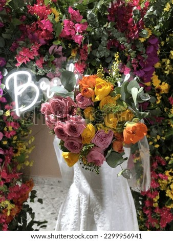 Beautiful bride to be in her bridal shower with colorful flowers and neon sign