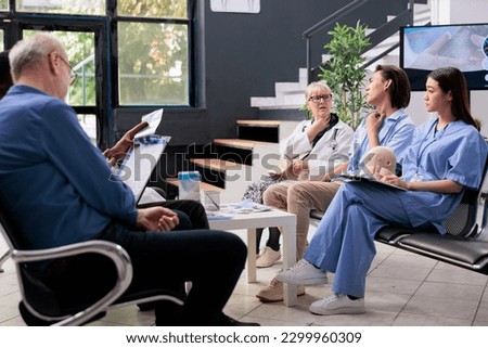 Diverse medical team helping injured patient with cervical collar removing neck brace after injury in hospital waiting area. Asian adult healing fracture after accident, medicine service
