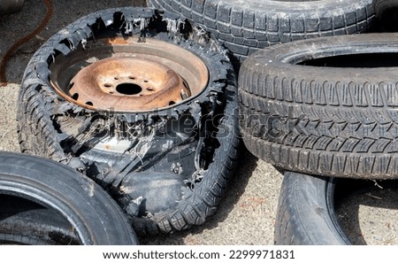 Worn wheels for recycling. Plant for burning tire dumps. Mountain of old tires. Used wheel junkyard. Pile of old tires and wheels for rubber recycling. Recycling concept