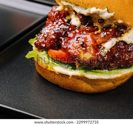 Appetizing crispy chicken burgers on black plates