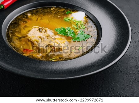 Chicken noodle soup in black plate