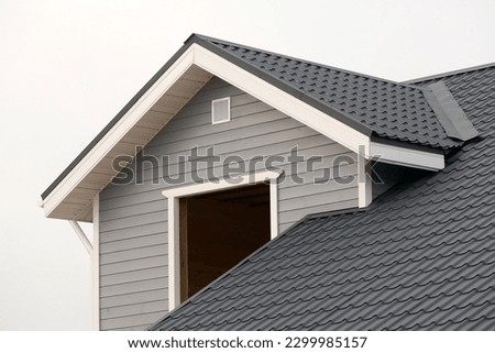 Wooden house, upper part, during construction, roof. Close-up part of the roof  ridge of the house made of wood white gray on an isolated background horizontally  Royalty-Free Stock Photo #2299985157