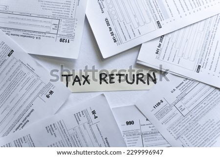 Different tax return forms on the table. Tax Return written in the middle. USA IRS Tax Return Royalty-Free Stock Photo #2299996947