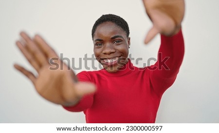 African american woman smiling confident doing frame gesture with hands over isolated white background