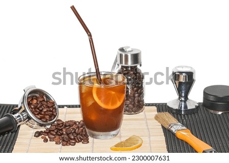 Americano Ice Coffee,with coffee beans spread around cup,coffee beans,tamper,lemon,bamboo bar matrefreshing and good feeling,concept picture for copy space and background.		
