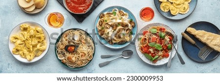 Pasta variety panorama. Italian food and drinks, overhead flat lay shot. Spaghetti marinara, mushroom, seafood pasta, wine, Parmesan cheese, ravioli Royalty-Free Stock Photo #2300009953