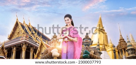 Beautiful asain woman gretting with Wat Phra Kaew, Emerald Buddha temple in background