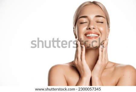 Portrait of happy smiling blond woman touches her face with pleasure, enjoys skincare cosmetic after effect, washes her skin with cleansing gel, hyaluronic acid for smooth face without blemishes.
