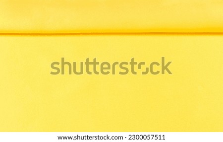 background seamless texture - yellow silk. Premium silk organza in pale yellow is an exceptional fabric, beautiful both on its own and as an accessory in terms of highlighting.