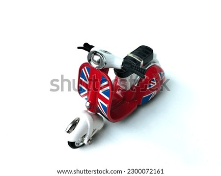 red and white vintage toy scooter on white background, side view.