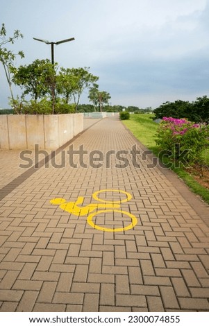 sign of a pedestrian path area for cyclists in a park, slightly overcast at dusk