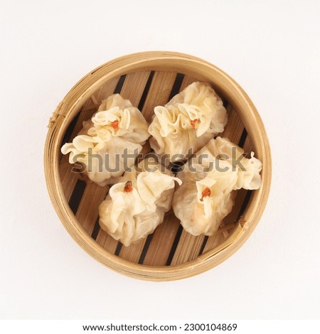Close up shot of dim sum. Dim sum is a Chinese dish of small steamed or fried savory dumplings containing various fillings, served as a snack or main course. Royalty-Free Stock Photo #2300104869