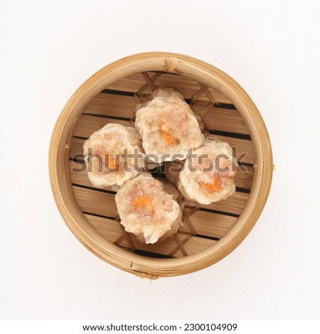 Close up shot of dim sum. Dim sum is a Chinese dish of small steamed or fried savory dumplings containing various fillings, served as a snack or main course. Royalty-Free Stock Photo #2300104909