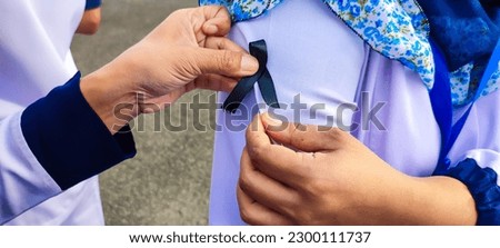 Black mourning ribbon. Black tape. put a black tape on the clothes of medical personnel.