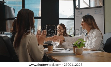 Young business signing a contract with her team or partnership. Discussing contract details, Making agreement at office.