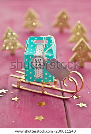 Little colorful present on sleigh with christmas decorations