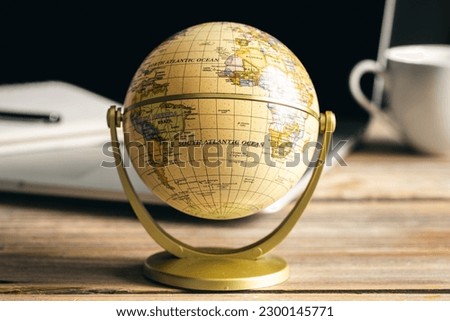 Close-up, Earth globe on a wooden desktop.