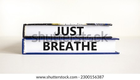 Just breathe and psychological symbol. Concept words Just breathe on beautiful books. Beautiful white table white background. Business psychological and Just breathe concept. Copy space