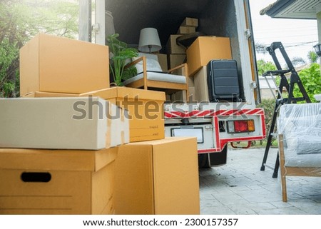 Boxes waiting to be moved into a new home,New home,Moving house day and real estate concept. Royalty-Free Stock Photo #2300157357