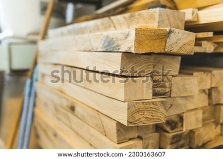 closeup shot of dozens of wooden planks in the workshop, woodworking concept. High quality photo