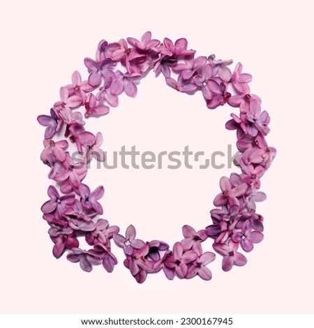 The letter O made of lilac flowers.  Square photo with white background.