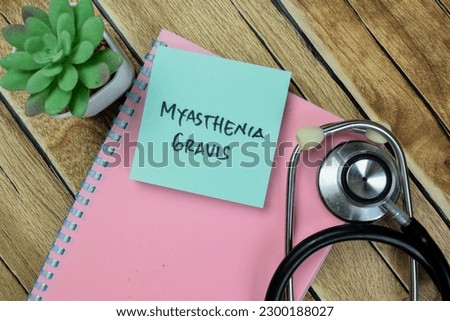 Concept of Myasthenia Gravis write on sticky notes isolated on Wooden Table. Royalty-Free Stock Photo #2300188027