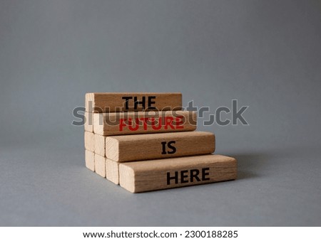 The future is here symbol. Concept words TThe future is here on wooden blocks. Beautiful grey background. Business and The future is here concept. Copy space.