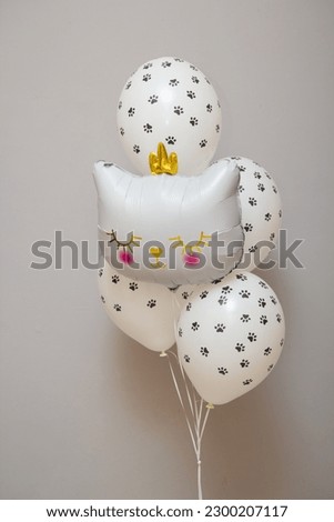 white balloons with a pattern of cat paws on a white background