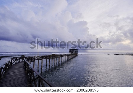 Beautiful landscape. Sunset on the seashore. Wooden bridge on Cloud Nine beach, Siargao Island Philippines. Royalty-Free Stock Photo #2300208395