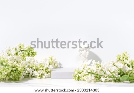Cosmetics skin care product presentation scene and display with copy space made with stone podium and blossom branch on white background. Studio photography.