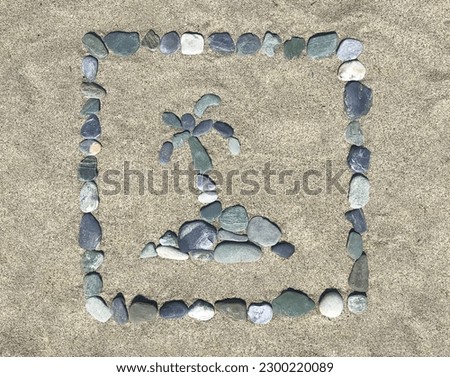 A composite image of small multicolor pebbles arranged on a sand beach shows a small island with a palm tree