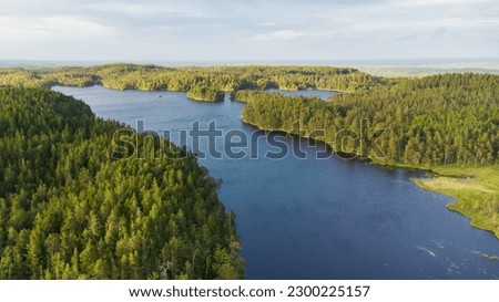 Aerial view of a swedish lake and forest landscape in beautiful evening light Royalty-Free Stock Photo #2300225157