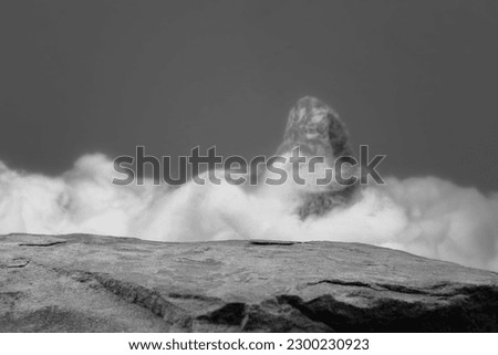 A Rock Ledge for a Product Display, Showing Close Detail the Centre Top Surface of the Stone with a Fictitious Cloud and Mountain Blurred Background. Royalty-Free Stock Photo #2300230923