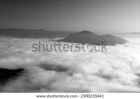 Black and white photo of the north of Portugal mountain landscape at dawn covered with white clouds