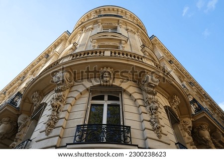 The facade of traditional French house with typical balconies and windows. Paris. Royalty-Free Stock Photo #2300238623