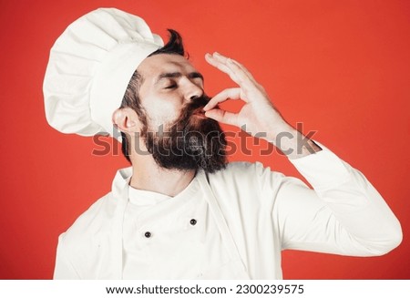 Chef shows sign ok, taste approval gesture. Chef with gesture for approving restaurant service. Professional chef in uniform with sign for delicious. Satisfied chef, cook or baker gesturing excellent. Royalty-Free Stock Photo #2300239575