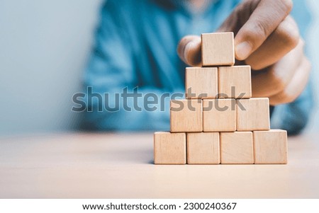 Businessman stacking blank wooden cubes on table with copy space , empty wooden cubes for input wording and infographic icon.