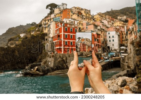 Tourist save memories using smartphone camera during travel to Italy. Cinque terre smartphone photo