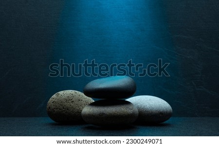 zen stones for podium stand pedestal platform background.grey and black oval stones on dark gray background for product presentation,background