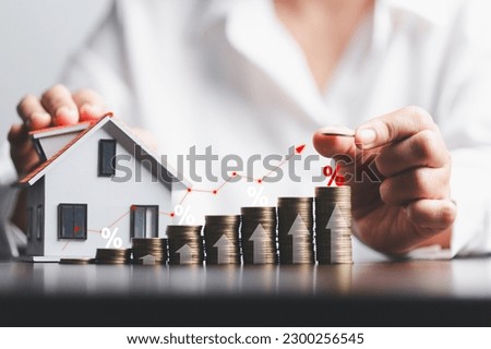 Business woman hand and stack coins money with up arrow and percentage symbol of Interest rate financial and mortgage rates. Icon percentage symbol and arrow pointing up. Royalty-Free Stock Photo #2300256545