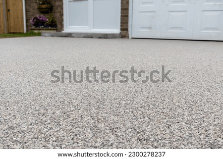 Newly laid resin driveway in front of a detached residential property Royalty-Free Stock Photo #2300278237