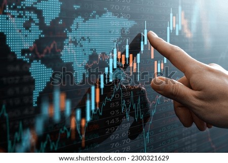Candlestick chart and data of world financial market.  Analyst pointing the chart. 
 Royalty-Free Stock Photo #2300321629
