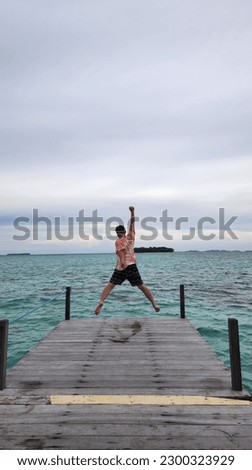 man jumping on the pier
