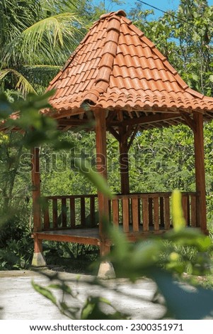 Gazebo is a shady, comfortable and relaxing place to rest against a backdrop of trees