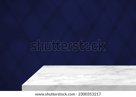 Minimal White Marble Table Corner with Shadow of Net on Blue Concrete Wall Background, Suitable for Product Presentation Backdrop, Display, and Mock up.