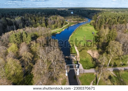 aerial view over dam lock sluice on lake impetuous waterfall Royalty-Free Stock Photo #2300370671