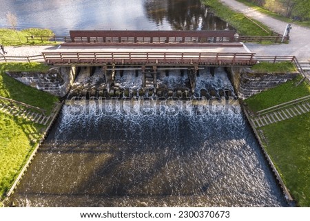 aerial view over dam lock sluice on lake impetuous waterfall Royalty-Free Stock Photo #2300370673