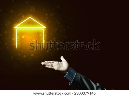 Hand of businessman touching with finger glowing home icon or symbol