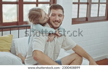 Little Girl kissing her dad on cheek, Happy father.